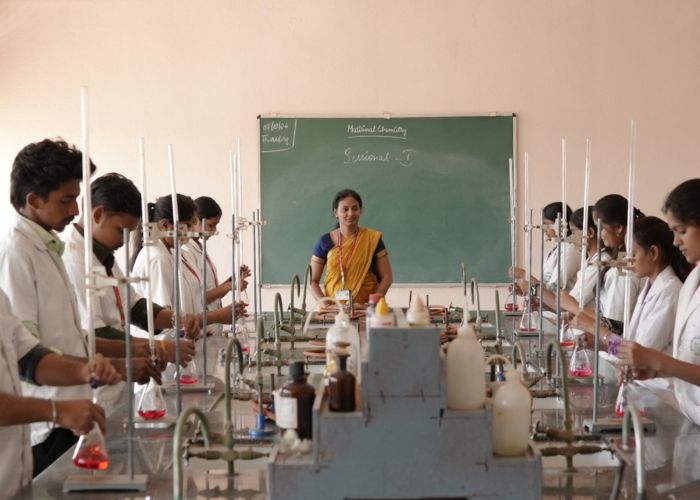 Mallige College of Pharmacy faculty teaching in modern classroom with smart board